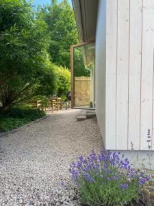 a garden with purple flowers next to a building at House by the ocean in Halmstad