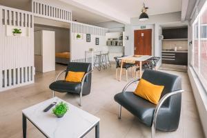 a living room with two chairs and a table at Gente del Sur - Towers in Ushuaia