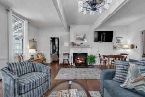 a living room with a couch and a fireplace at Lemon LaBruce 6 Bdrm Oceanfront Beach House in Pawleys Island