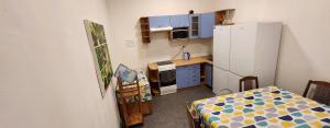 a small kitchen with a refrigerator and a table at Palangos Kopa in Palanga