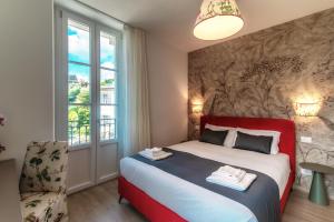 Voodi või voodid majutusasutuse Hotel Ristorante La Vignetta Cernobbio toas
