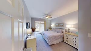 a bedroom with a bed and a dresser and a television at 2 Bdrm Lakeside Villa Scenic View With Amenities in Pawleys Island