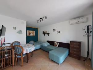 a living room with a couch and a table at Villa Anastasia in Sinemorets