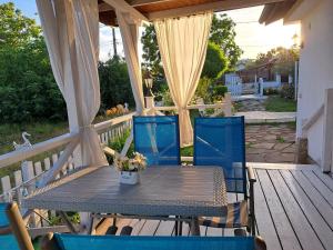 a wooden table and chairs on a deck at Villa Anastasia in Sinemorets