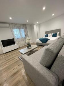 a living room with a couch and a bed at Casa Santyana in Amarante