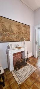 a living room with a fireplace with a large painting on the wall at Enza Domus in Bari