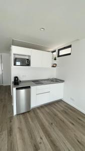 a kitchen with white cabinets and a counter top at Casa Santyana in Amarante +12 photos