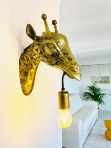 a head of a giraffe hanging on a wall at Studio Square - zonrijke studio - zuidgericht balkon - dichtbij strand in Middelkerke