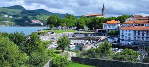 a view of a town with a river and buildings at Rincón del Mar, Mundaka in Mundaka