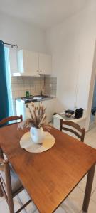 a wooden table with a bowl on it in a kitchen at KANALI HOLIDAYS APARTMENT 4 in Kanali +1 photo