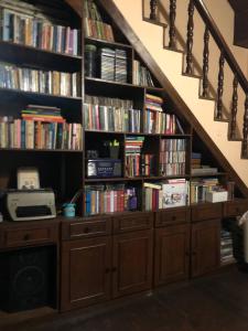 a book shelf filled with books under a staircase at Casa Amarela in Belo Horizonte +18 photos