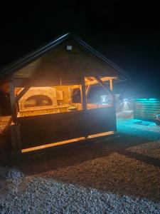a small cabin with a roof at night at Vikendica IVA in Pale