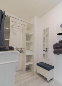 a bathroom with white shelves and a stool in a room at Gite De Pène Blanque in Arbas +18 photos