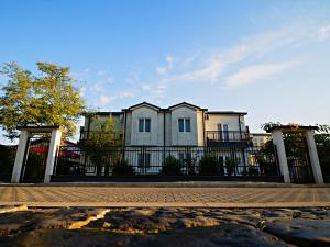 a house with a fence in front of it at Elektra - Sulina in Sulina