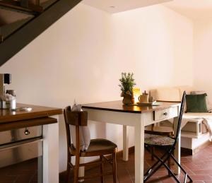 a kitchen with a table and chairs in a room at Gipsy Maisonette in Lucca