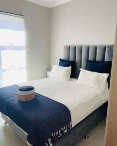 a bedroom with a large bed with a blue headboard at Dubai 8 in Midrand