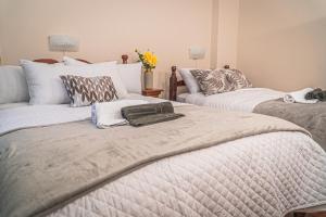 a bedroom with two beds with towels on them at Ukuku Hostel & Rooftop - Quito in Quito