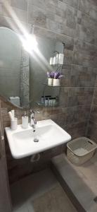 a bathroom with a sink and a mirror at AXD Evangelia's apartment in Alexandroupoli +13 photos
