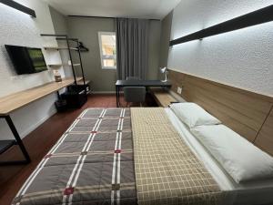 Postel nebo postele na pokoji v ubytování Hotel 10 Uniao da Vitoria
