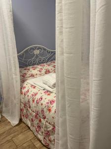 a bedroom with a bed with a curtain at Itaka in LʼAquila