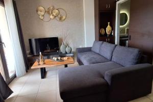 a living room with a couch and a coffee table at Διαμερίσματα CANNA in Samos