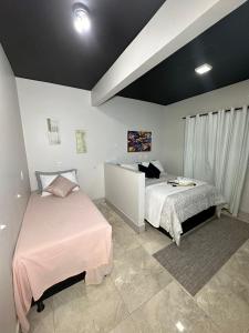 a bedroom with two beds in a room at Riacho Hotel in Brasília