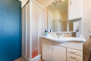 a bathroom with a sink and a mirror at Casa vacanze della Corte in Sestu +13 photos