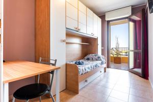 a bedroom with a bed and a desk and a table at Casa vacanze della Corte in Sestu