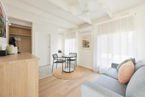 a living room with a couch and a table at The Keith Motel in Tootgarook +7 photos