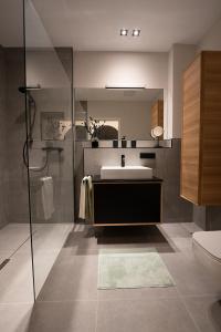 a bathroom with a sink and a mirror at Stay Boardinghouse in Würselen