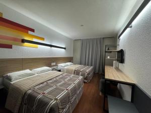 Postel nebo postele na pokoji v ubytování Hotel 10 Uniao da Vitoria