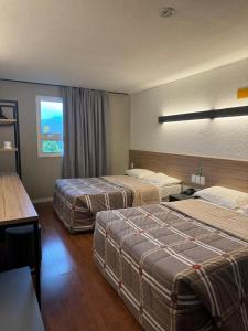 Postel nebo postele na pokoji v ubytování Hotel 10 Uniao da Vitoria