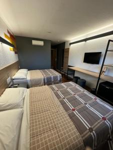Postel nebo postele na pokoji v ubytování Hotel 10 Uniao da Vitoria + 11 fotografií