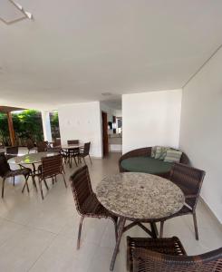 a dining room with chairs and tables and tablesktop at Flat Premium Itaperapuã in Porto Seguro +76 photos