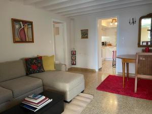 a living room with a couch and a table at Peculiar Garden Apartment in Mytilene