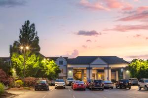 a parking lot with cars parked in front of a building at Best Western Hartford Hotel and Suites in Hartford
