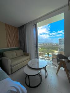 a living room with a couch and a table at Suite con excelente vista al mar in Santa Marta