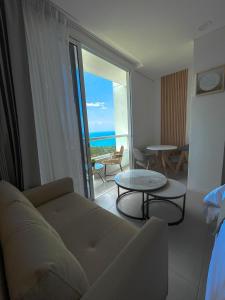 a living room with a couch and a view of the ocean at Suite con excelente vista al mar in Santa Marta +3 photos