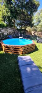 a small pool with a chair in the grass at villa Paty in Bonifacio +10 photos