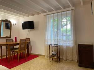 a living room with a table and a window at Peculiar Garden Apartment in Mytilene