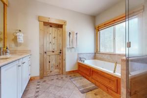 a bathroom with a bath tub and a window at West Shore Retreat in Tahoma +25 photos