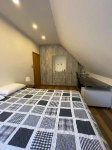 a attic bedroom with a bed and a room at habitación casa familiar in Valdivia