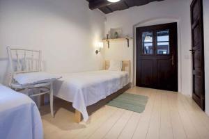 a bedroom with a bed and a chair and a door at Apartment in Sukoró 34975 in Sukoró