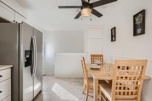 a kitchen with a dining table and a ceiling fan at Serene, Spacious Home in Quiet Neighborhood with Fenced Yard in Aurora