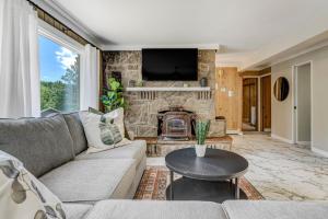 a living room with a couch and a fireplace at Upper Stone Lodge - Hot Tub & Game Room - Upper Unit in Cascade-Chipita Park