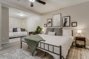 a bedroom with a large bed and a couch at Lower Stone Lodge - Hot Tub - Game Room - Lower Unit in Cascade-Chipita Park