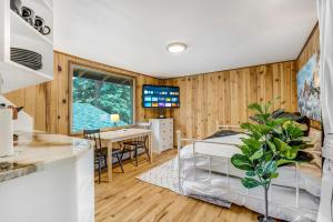 a bedroom with a bed and a dining room with a table at Pikes Peak Stone Cottage - Hot Tub & Game Room in Cascade-Chipita Park +11 photos