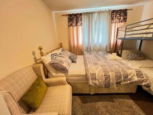 a bedroom with a bed and a couch at Residence Solitaire in Woodley