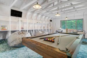 a room with a pool table and two bean chairs at Pikes Peak Stone Cottage - Hot Tub & Game Room in Cascade-Chipita Park