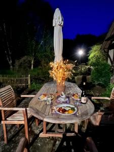 a table with a plate of food and a statue at Stay with Robin in Dorking